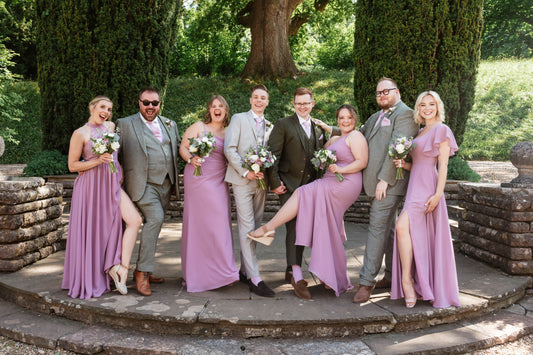 Groom and groomsmen wearing ties that perfectly match bridesmaids’ dresses at an elegant wedding