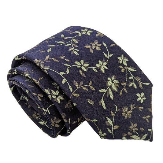 A patterned necktie with navy and sage green floral design, made from silk or polyester fabric.