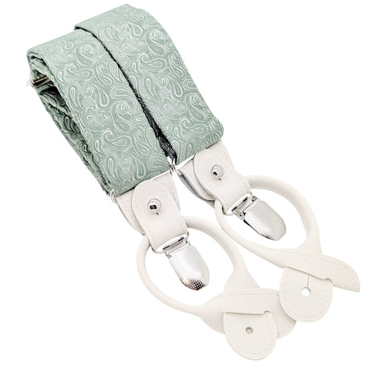 A pair of suspenders with a sage green paisley patterned fabric strap and cream-colored leather clips and loops, shown on a plain white background.
